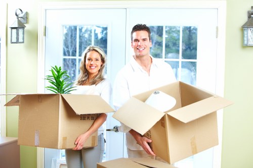 Professional movers handling office equipment in a St Johns Wood building